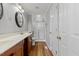 Bathroom with double vanity, wood cabinets, and a glass shower enclosure at 20 Nicklaus Way, Clayton, NC 27520