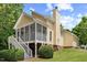 Exterior shot of the back of the home with screened porch and stairs at 20 Nicklaus Way, Clayton, NC 27520