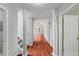 Bright foyer with hardwood floors, white trim, and view into the living room at 20 Nicklaus Way, Clayton, NC 27520