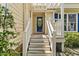 Inviting front porch with white railing and a black front door with house number 20 at 20 Nicklaus Way, Clayton, NC 27520