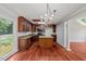 Kitchen features hardwood floors, granite countertops, center island, and pendant lighting at 20 Nicklaus Way, Clayton, NC 27520