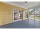 Screened porch with wood flooring, yellow siding, and white trim at 20 Nicklaus Way, Clayton, NC 27520