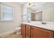 Well-lit bathroom features a double vanity with wood cabinets and framed mirror at 204 Plantation Dr, Youngsville, NC 27596