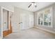 Neutral bedroom with two closets, window, and ceiling fan at 204 Plantation Dr, Youngsville, NC 27596