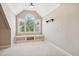 An alcove with arched window provides lots of natural light for this bonus room with neutral walls and plush carpeting at 204 Plantation Dr, Youngsville, NC 27596