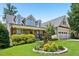 Beautifully landscaped front yard with stone accents and a covered porch on a sunny day at 204 Plantation Dr, Youngsville, NC 27596
