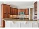 Kitchen with granite countertops, wood cabinets, and modern stainless steel appliances at 204 Plantation Dr, Youngsville, NC 27596