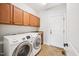 Bright laundry room equipped with Samsung washer and dryer and storage cabinets at 204 Plantation Dr, Youngsville, NC 27596