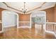Living room with beautiful hardwood floors, archways, and stylish ceiling design at 204 Plantation Dr, Youngsville, NC 27596