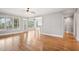 Bright living room with hardwood floors, large windows, and access to an outdoor space at 204 Plantation Dr, Youngsville, NC 27596