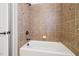 Modern shower features tiled walls with decorative accent tiles, and bronze shower head and faucet at 204 Plantation Dr, Youngsville, NC 27596