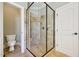 Shower features glass enclosure, built-in seating and tiled walls with mosaic accents at 204 Plantation Dr, Youngsville, NC 27596