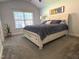 Comfortable bedroom featuring a large window, ceiling fan, and a spacious layout great for relaxing at 205 Braxcarr St, Holly Springs, NC 27540