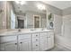 Bathroom with double vanity, large mirror, and neutral decor at 2069 White Pond Ct, Apex, NC 27523