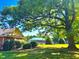 View of community amenities including the pool and clubhouse from a tree shaded yard at 2069 White Pond Ct, Apex, NC 27523