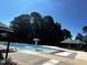 Large community pool with a splash feature and shaded seating areas at 2069 White Pond Ct, Apex, NC 27523