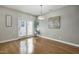 Well-lit dining area with hardwood floors, modern chandelier, and access to outdoor patio at 2069 White Pond Ct, Apex, NC 27523