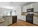 Kitchen with stainless steel appliances, granite countertops, and white cabinets at 2069 White Pond Ct, Apex, NC 27523
