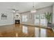 Bright living room featuring hardwood floors, fireplace, ceiling fan, and patio access for seamless indoor-outdoor living at 2069 White Pond Ct, Apex, NC 27523