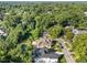 Stunning aerial view of a lush neighborhood with mature trees and a home with a private backyard pool at 2114 Cowper Dr, Raleigh, NC 27608