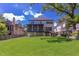 Expansive backyard featuring a well-maintained lawn and a screened porch perfect for outdoor gatherings at 2114 Cowper Dr, Raleigh, NC 27608