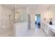 Bathroom featuring a glass-enclosed shower, a bench, and double vanities at 2114 Cowper Dr, Raleigh, NC 27608