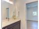 Stylish bathroom featuring a modern vanity, light countertop, and decorative mirror at 2114 Cowper Dr, Raleigh, NC 27608
