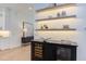 Elegant butler pantry with floating shelves and a wine refrigerator for sophisticated entertaining at 2114 Cowper Dr, Raleigh, NC 27608