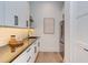 Bright Butler's Pantry features stainless steel appliances, a sink, white cabinets, and plenty of storage at 2114 Cowper Dr, Raleigh, NC 27608