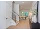 Entryway featuring hardwood floors, a stairway, and a glimpse into the dining area at 2114 Cowper Dr, Raleigh, NC 27608