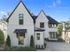 Charming home featuring white brick, contrasting black trim, modern windows, and manicured landscaping at 2114 Cowper Dr, Raleigh, NC 27608
