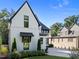 Beautifully landscaped home with modern design elements, including black trim and awning details at 2114 Cowper Dr, Raleigh, NC 27608