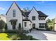 Elegant two-story home showcasing a white exterior, black trim, gabled roof, and manicured landscaping at 2114 Cowper Dr, Raleigh, NC 27608