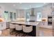 Modern kitchen with sleek white cabinets, an island with seating, and stainless steel appliances at 2114 Cowper Dr, Raleigh, NC 27608