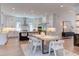 Bright, open-concept kitchen and dining area with modern white cabinets and stainless steel appliances at 2114 Cowper Dr, Raleigh, NC 27608