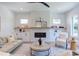 Cozy living room with contemporary decor, fireplace, built-in shelving, and comfortable seating arrangement for relaxation and socializing at 2114 Cowper Dr, Raleigh, NC 27608