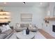Stylish living room with modern furnishings, a decorative fireplace and custom built-in shelving creating a cozy atmosphere at 2114 Cowper Dr, Raleigh, NC 27608