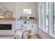 Comfortable chair by bright window, beside modern fireplace, shelf display and storage; a relaxing living room seating area at 2114 Cowper Dr, Raleigh, NC 27608