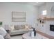 Cozy living room showcasing contemporary design, stylish sofa arrangement, fireplace, and custom built-in display shelving at 2114 Cowper Dr, Raleigh, NC 27608