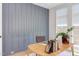 Stylish office space showcasing a statement wall, wooden desk and a window with natural light at 2114 Cowper Dr, Raleigh, NC 27608