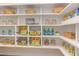Walk-in pantry with white shelving, baskets, canned goods, jars, and snacks at 2114 Cowper Dr, Raleigh, NC 27608