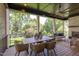 Covered patio with outdoor dining table, cushioned chairs, ceiling fan, and backyard view at 2114 Cowper Dr, Raleigh, NC 27608