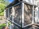 Inviting screened porch features an outdoor dining area with black railings for relaxed living at 2114 Cowper Dr, Raleigh, NC 27608