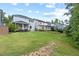 Lush backyard with manicured lawn, and view of neighboring houses at 217 Macy Grove Dr, Chapel Hill, NC 27517
