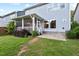 Backyard view of house with screened porch and brick patio at 217 Macy Grove Dr, Chapel Hill, NC 27517