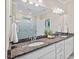Elegant bathroom featuring double sinks, granite countertops, and a large mirror at 217 Macy Grove Dr, Chapel Hill, NC 27517
