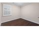 Well-lit bedroom with hardwood floors, a bright window, and neutral walls at 217 Macy Grove Dr, Chapel Hill, NC 27517
