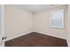 Cozy bedroom with hardwood floors, neutral walls, and natural light from the window at 217 Macy Grove Dr, Chapel Hill, NC 27517