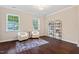 Bedroom featuring hardwood floors, two chairs, and shelving unit at 217 Macy Grove Dr, Chapel Hill, NC 27517