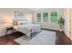 Bedroom with large windows, modern decor, and hardwood floors at 217 Macy Grove Dr, Chapel Hill, NC 27517